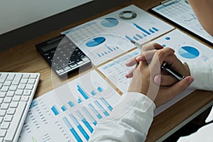 Businessman working with income statement document on the wood t