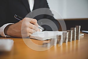 Businessman working with income statement document on the wood table.Business concept