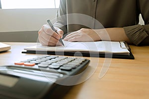 Businessman working with income statement document on the wood table. Business concept.