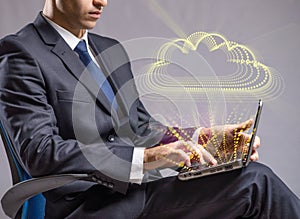 The businessman working with laptop in cloud computing concept