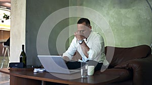 Businessman working on laptop computer at home office. Male professional typing on laptop keyboard at office workplace