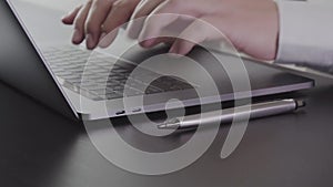 Businessman working with laptop computer on wooden desk in modern office