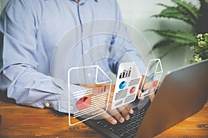 Businessman working on a laptop with electronic document icons virtual screen on the desk in the office. An approved electronic