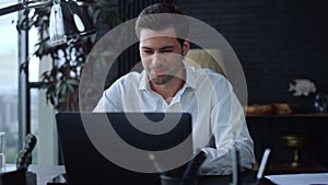 Businessman working on laptop at home office. Professional typing on keyboard