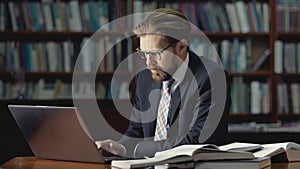 Businessman working laptop in library