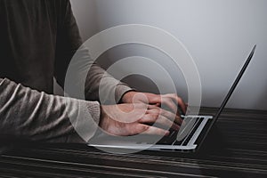 Businessman working on laptop for new project. laptop on the wooden table. Blurred background, horizontal mockup