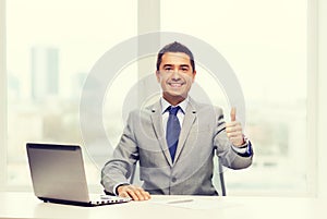 Businessman working with laptop in office