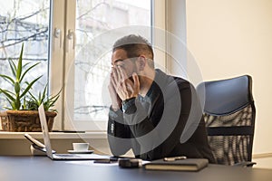 businessman working on laptop in office eyes hurt