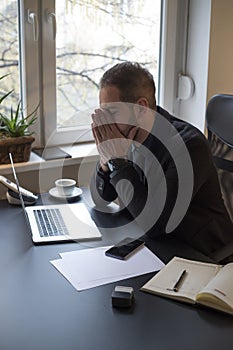 businessman working on laptop in office making phone call nervous and angry