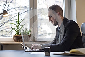 businessman working on laptop in office taking notes