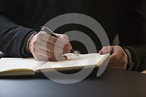 businessman working on laptop in office taking notes