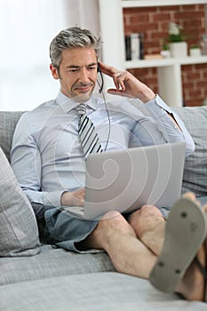 Businessman working on laptop relaxed on the couch