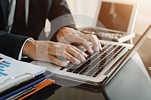 Businessman working on laptop on the table at home office.