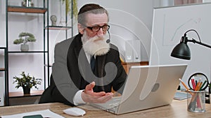 Businessman working on laptop wearing headset, call center support service operator office helpline