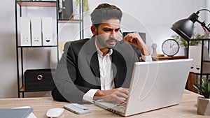 Businessman working on laptop wearing headset, call center support service operator office helpline