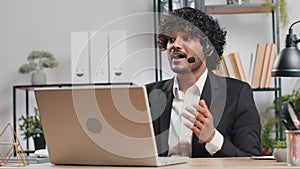 Businessman working on laptop wearing headset, call center support service operator office helpline