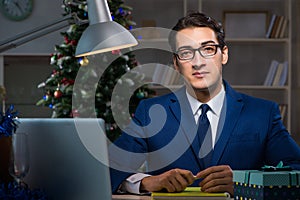 The businessman working late on christmas day in office