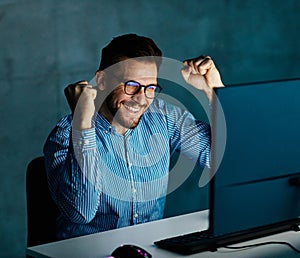 businessman working late night business computer man office winner win light dark young internet success celebrating