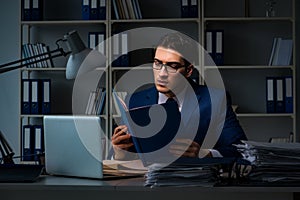 The businessman working late at night in office for overtime bonus