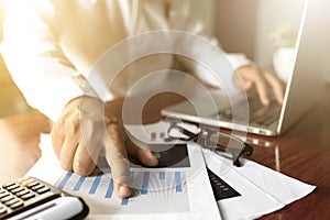 Businessman working with modern workplace with laptop on wood table, Man hand on laptop keyboard for work from home, Overhead view