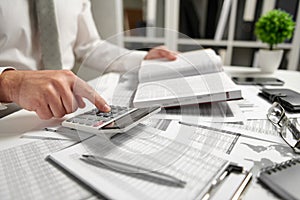 Businessman working at office and calculating finance, reads and writes reports. Business financial accounting concept