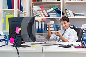 Businessman working in the office with piles of books and papers