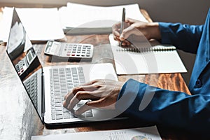 businessman working in office with using a calculator to calculate the numbers finance accounting concept