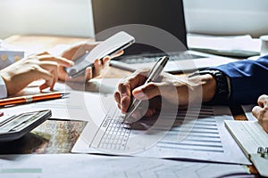 businessman working in office with using a calculator to calculate the numbers finance accounting concept