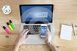 Businessman working online on laptop and smartphone from home