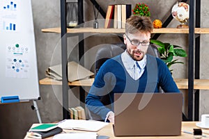 Businessman working on online project on laptop