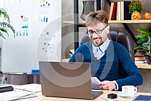 Businessman working on online project on laptop