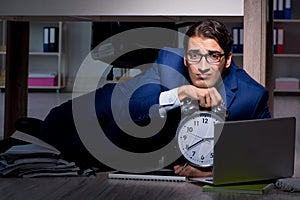 The businessman working overtime long hours late in office
