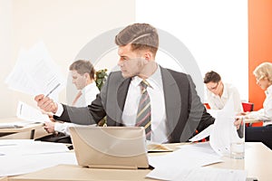 Businessman working with paper and laptop