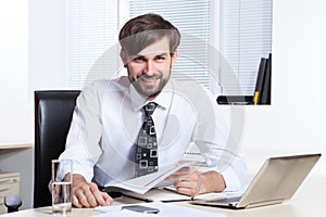 Businessman working with paper and laptop