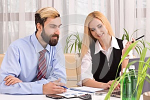 Businessman working with pretty businesswoman in office