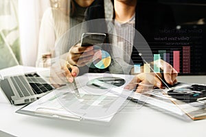 Businessman working with smart phone and laptop and digital tablet computer in office with digital marketing media in virtual icon