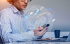 Businessman working with smartphone and laptop, fingerprint hud hologram