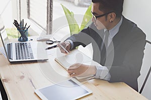 Businessman working with smartphone, tablet and computer.