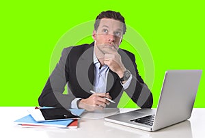 Businessman working in stress at office desk computer isolated green chroma key