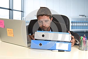 Businessman working in stress at office laptop computer looking exhausted and overwhelmed