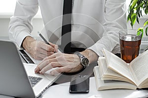 Businessman working in workplace.Stylish man in shirt and tie.