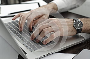 Businessman working in workplace.Stylish man in shirt and tie.