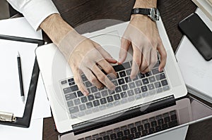 Businessman working in workplace.Stylish man in shirt and tie.