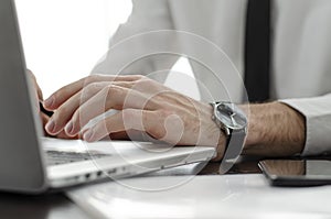 Businessman working in workplace.Stylish man in shirt and tie.