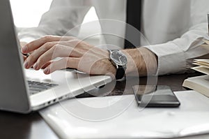 Businessman working in workplace.Stylish man in shirt and tie.