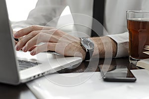 Businessman working in workplace.Stylish man in shirt and tie.