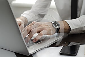 Businessman working in workplace.Stylish man in shirt and tie.