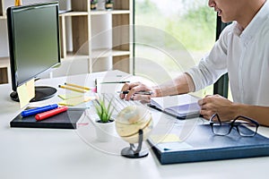 Businessman working writing business plan document and graphic designer with computer in office