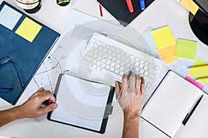 Businessman working writing making note business plan and graphic designer with computer in office, top view workspace