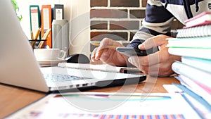 Businessman works with a smartphone and typing on keyboard